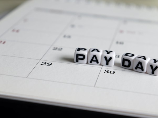 Pay day written on blocks on calendar